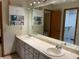 Bathroom with double vanity, cabinets, and a large mirror reflecting the room at 5050 Hidden Springs Blvd, Orlando, FL 32819