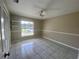 Bedroom showcasing tile flooring, a ceiling fan, and natural light at 5050 Hidden Springs Blvd, Orlando, FL 32819