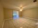 Bedroom with tile flooring, ceiling fan, and sliding glass door to the exterior at 5050 Hidden Springs Blvd, Orlando, FL 32819