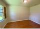 Modest bedroom showcasing wood-look flooring and a window with natural light at 5050 Hidden Springs Blvd, Orlando, FL 32819
