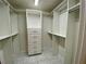 Spacious walk-in closet with white shelving and drawers for optimal storage at 5050 Hidden Springs Blvd, Orlando, FL 32819