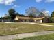 Charming single-story home with a well-maintained lawn and a two car garage at 5050 Hidden Springs Blvd, Orlando, FL 32819