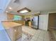 Spacious kitchen with stainless appliances, light wood cabinets, and tile flooring at 5050 Hidden Springs Blvd, Orlando, FL 32819