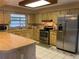 Well-lit kitchen features stainless steel appliances and tile floors at 5050 Hidden Springs Blvd, Orlando, FL 32819