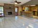 Living room features a fireplace and opens up to the adjacent kitchen and dining areas at 5050 Hidden Springs Blvd, Orlando, FL 32819