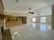 Bright open-concept living room features tile floors, brick fireplace and open kitchen at 5050 Hidden Springs Blvd, Orlando, FL 32819