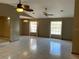 Open-concept living room featuring tile floors, fan lighting, and natural light at 5050 Hidden Springs Blvd, Orlando, FL 32819