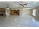 Spacious open-concept living room and kitchen with vaulted ceilings and tile flooring at 5050 Hidden Springs Blvd, Orlando, FL 32819