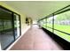 Enclosed back patio with screened windows and views of the backyard at 5050 Hidden Springs Blvd, Orlando, FL 32819