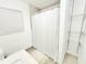 Compact bathroom featuring a shower with a curtain, shelving and a vanity at 509 Grove Ave, Orlando, FL 32805