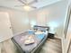 Bedroom with laminate flooring, ceiling fan, and bedside tables at 509 Grove Ave, Orlando, FL 32805