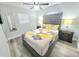 Bedroom featuring a gray tufted headboard, ceiling fan, and laminate flooring at 509 Grove Ave, Orlando, FL 32805