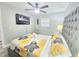 Bedroom featuring a gray tufted headboard, ceiling fan, and flat screen television at 509 Grove Ave, Orlando, FL 32805