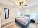 Cozy bedroom features stylish ceiling fan, calming wall color, and sleek grey wood-look flooring at 509 Grove Ave, Orlando, FL 32805