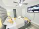 Bedroom featuring a gray tufted headboard, ceiling fan, and flat screen television at 509 Grove Ave, Orlando, FL 32805