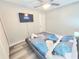 Bedroom featuring laminate flooring, ceiling fan, and flat screen television at 509 Grove Ave, Orlando, FL 32805