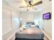 Well lit bedroom featuring a mounted TV, sleek grey wood-look flooring and comfy decor at 509 Grove Ave, Orlando, FL 32805