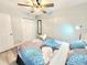 Bright bedroom featuring a ceiling fan, closet, and mirror for a comfortable and functional space at 509 Grove Ave, Orlando, FL 32805