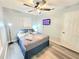 Comfortable bedroom with mounted TV, closet, calming colors, and a ceiling fan for restful nights at 509 Grove Ave, Orlando, FL 32805