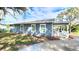 Charming blue home with white trim, front porch, and freshly landscaped mulch at 509 Grove Ave, Orlando, FL 32805