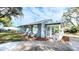 Quaint blue home featuring a welcoming porch, fresh mulch, and curb appeal at 509 Grove Ave, Orlando, FL 32805