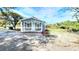 A cozy blue house with a welcoming porch, offering a serene and comfortable living space at 509 Grove Ave, Orlando, FL 32805