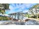 Quaint blue home featuring a welcoming porch, fresh mulch, and curb appeal at 509 Grove Ave, Orlando, FL 32805