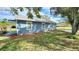 Side view of a charming blue home featuring a well maintained lawn, and mulch landscaping at 509 Grove Ave, Orlando, FL 32805