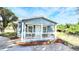 Charming blue home with a white picket porch, perfect for enjoying sunny afternoons at 509 Grove Ave, Orlando, FL 32805