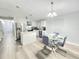 Bright open space combines kitchen with island, stainless appliances, and a modern dining area at 509 Grove Ave, Orlando, FL 32805