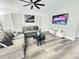 Modern living room with gray sofas, a stylish ceiling fan, and contemporary decor at 509 Grove Ave, Orlando, FL 32805