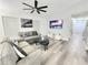 Bright living room featuring a ceiling fan, modern decor, and a television at 509 Grove Ave, Orlando, FL 32805