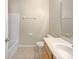 Bathroom includes a single sink vanity and tub with white tile surround at 5236 Shale Ridge Trl, Orlando, FL 32818