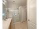 Bathroom features a glass-enclosed shower, single sink vanity and tile flooring at 5236 Shale Ridge Trl, Orlando, FL 32818