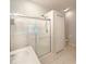 Bathroom featuring tiled walk-in shower with glass door, vanity and tile flooring at 5236 Shale Ridge Trl, Orlando, FL 32818