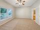 Bright bedroom with a ceiling fan, plush carpet, and large windows for natural light at 5236 Shale Ridge Trl, Orlando, FL 32818