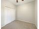 Neutral bedroom includes carpet and double door closet at 5236 Shale Ridge Trl, Orlando, FL 32818