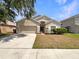 Charming single-story home featuring a well-maintained front yard and two-car garage at 5236 Shale Ridge Trl, Orlando, FL 32818