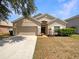 Charming single-story home featuring a well-maintained front yard and two-car garage at 5236 Shale Ridge Trl, Orlando, FL 32818