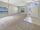 Bright living room boasts plush carpet, large windows, and a modern chandelier at 5236 Shale Ridge Trl, Orlando, FL 32818