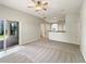 Bright living room boasts neutral tones, a ceiling fan and access to the outdoors at 5236 Shale Ridge Trl, Orlando, FL 32818
