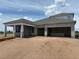 New construction home featuring a block exterior, covered porch and a spacious three car garage at 5391 Park Guell St, St Cloud, FL 34771