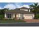 Charming single-Gathering home featuring a brick driveway, three-car garage, and manicured landscaping at 5391 Park Guell St, St Cloud, FL 34771