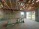 Unfinished living room with exposed beams and a sliding glass door, perfect for customization at 5391 Park Guell St, St Cloud, FL 34771