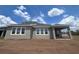 The house's rear showcases large, bright windows and a covered patio, perfect for outdoor relaxation and entertaining at 5391 Park Guell St, St Cloud, FL 34771