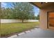Large grassy backyard, fenced, and providing a view from the covered patio at 5525 Oakworth Pl, Sanford, FL 32773