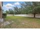 Spacious fenced backyard with mature trees and ample green space, perfect for outdoor activities at 5525 Oakworth Pl, Sanford, FL 32773