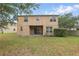 Exterior view of a two-story home featuring a spacious green backyard at 5525 Oakworth Pl, Sanford, FL 32773