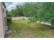 Spacious backyard featuring green grass, fenced perimeter, and mature trees at 5525 Oakworth Pl, Sanford, FL 32773