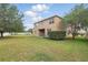 Expansive backyard featuring a well-maintained lawn and mature trees with a covered patio, perfect for outdoor gatherings at 5525 Oakworth Pl, Sanford, FL 32773